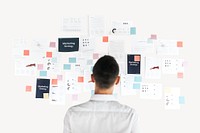 Businessman looking at marketing plan on the wall psd