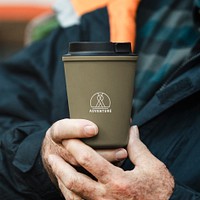 Holding reusable cup mockup psd in green