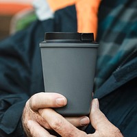 Holding reusable cup mockup psd in gray