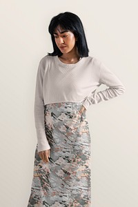 Woman wearing beige cropped top over patterned dress, autumn apparel fashion design