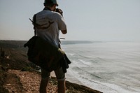 Photographer taking photo of seascape