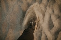 Man walking through the sand
