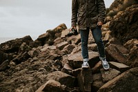 Photographer walking through rugged terrain