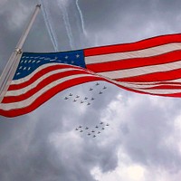 Aircraft fly overhead in formation at the EAA AirVenture Oshkosh, Wisconsin.USDA Photo by Preston Keres. Original public domain image from Flickr