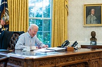 President Joe Biden talks on the phone with British Prime Minister Boris Johnson Saturday, Jan. 23, 2021, in the Oval Office of the White House.