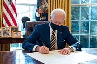 President Joe Biden signs the commission for Lloyd Austin to be Secretary of Defense Friday, Jan. 22, 2021, in the Oval Office of the White House.