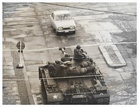 U.S. Tank at Checkpoint CharlieOct. 26, 1961. A U.S. tank stands guard at the border, indicated by the white line, as a car carrying U.S. diplomats returns from East Berlin. From the booklet "A City Torn Apart: Building of the Berlin Wall." . Original public domain image from Flickr