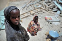 Two girls help to prepare food for builders working on Haji Mohamud Hilowle Primary School in Wadajir district, Mogadishu.