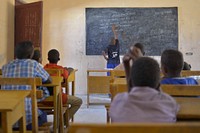 A class two student leads his fellow students during a reading session in Mogadishu, Somalia. Original public domain image from Flickr