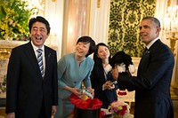President Barack Obama holds up a Bo golf club cover, a gift given to him by Prime Minister Shinzo Abe and Mrs. Akie Abe at Akasaka Palace in Tokyo, Japan, April 24, 2104.