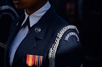 A sunray illuminates a uniform belonging to an airman in the Air Force Honor Guard during a wreath-laying ceremony at the Tomb of the Unknowns at Arlington National Cemetery in Arlington, Va., Nov. 11, 2014. Original public domain image from <a href="https://www.flickr.com/photos/dodnewsfeatures/15765804841/" target="_blank">Flickr</a>