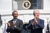 President Barack Obama and former President Bill Clinton applaud during the 20th anniversary of the AmeriCorps national service program on the South Lawn of the White House, Sept. 12, 2014.