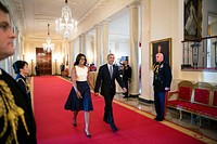 President Barack Obama and First Lady Michelle Obama walk down the Cross Hall to the Presidential Medal of Freedom ceremony in the East Room of the White House, Nov. 24, 2014.
