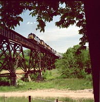 Rail Shipments, Shandon Trestle &ndash; In support of the Waste Pits Remedial Action Project WPRAP), the train trestle near Okeana, Ohio, had 52 timber spans replaced with 16 steel girder/beam spans. Here a WPRAP until train passes over the upgraded trestle. Original public domain image from <a href="https://www.flickr.com/photos/departmentofenergy/28765516910/" target="_blank">Flickr</a>