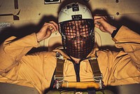 Inside a smokejumper plane, one of the crew members gets ready and focused. (Courtesy photo by Cole Barash). Original public domain image from Flickr