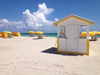 Yellow umbrellas on beach. Free public domain CC0 photo.