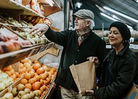 Couple at fresh market, buying fruits