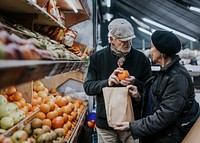 Husband & wife at supermarket, buying fruits