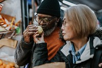 Couple shopping at supermarket, buying fruits