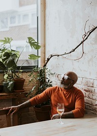 Man drinking wine alone at restaurant 
