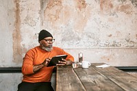 African American man using tablet at coffee shop