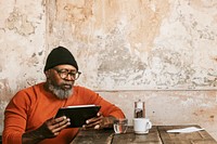 African American man using tablet at coffee shop