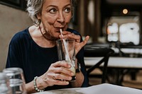 Woman drinking cocktail from straw