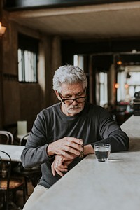 Man waiting at a bar and checking watch