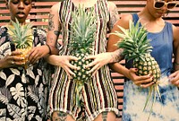 Pretty cool girls holding pineapples