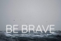 Psd be brave white neon word typography on ocean background
