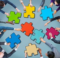 Group of Business People Forming Jigsaw Puzzle