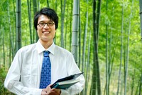 Chinese businessman in a bamboo grove.