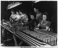 Aluminum paint production. Women work alongside of men in this Midwest aluminum factory now converted to production of war materials. These young workers are assembling 37mm armor-piercing shot prior to heat treating operations. Sourced from the Library of Congress.