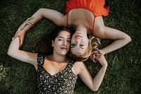 Lesbian couple lying in the grass