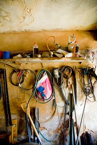 Messy garage wall with ropes and wires