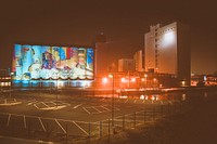 Colorful art on a building wall at night