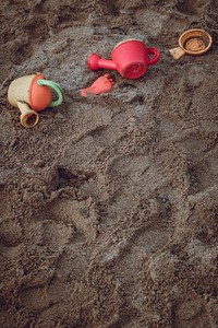 Watering cans on the sand
