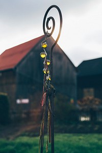 A metal swirly stick with crystal ornament