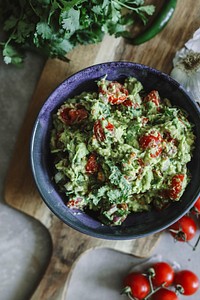 Homemade guacamole with cherry tomatoes food photography recipe idea