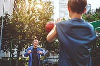 Young boy playing basketball with dad