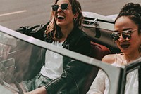 Boho girls on convertible car, summer road trip to the festival