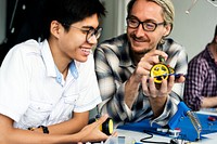 Electrical technicians working on robot electronics parts