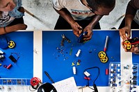 An aerial view of people working together in a mechanical workshop
