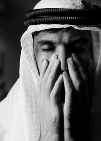 Portrait of thoughtful arab man with black background
