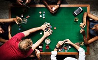 Diverse group playing poker and socialising 