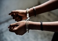 Closeup of arrested hands with handcuffs