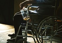 Alcoholic man sitting in a wheelchair