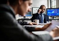 African American businessman making a call in a business meeting