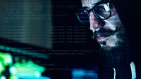 Closeup of hacker working on computer