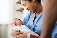 A newborn baby with her mother in a hospital